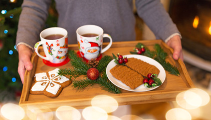 Senior woman holding tray of Christmas cookies
