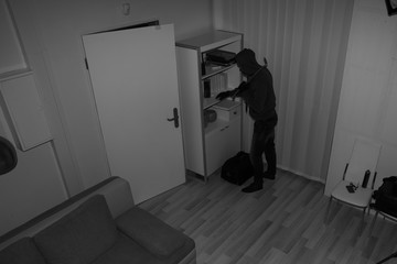 Robber Searching House For Valuables
