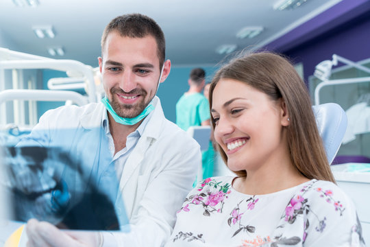 Dentist explaning oral x ray to patient