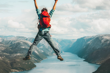 Happy Man jumping above Lysefjord cliff Travel Lifestyle success adventure emotional concept active...