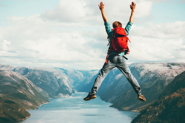 Happy Man jumping Travel Lifestyle adventure concept active summer vacations with backpack outdoor...