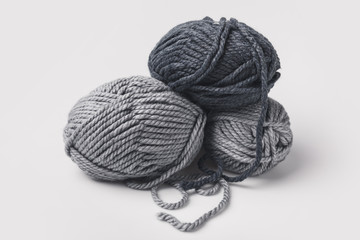 three grey yarn balls isolated on white