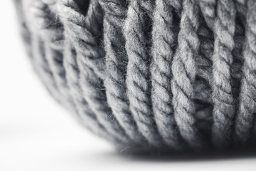 close up view of grey yarn ball on white background