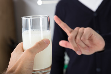 Person Rejecting Glass Of Milk