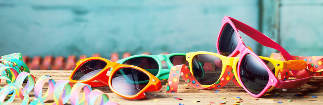 Colorful sunglasses and party streamers