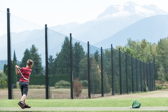 Boy playing golf at a golf course