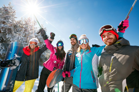 smiling skier&rsquo;s friends in snow mountains