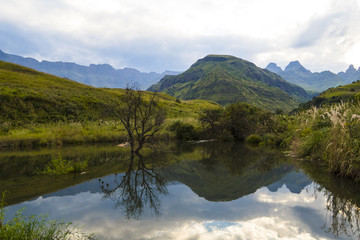 Fototapeta na wymiar Breathtaking view of the mountains and lake in Drakensberg, South Africa,