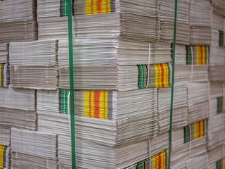Pile of prints or newspapers stack on a pallet.