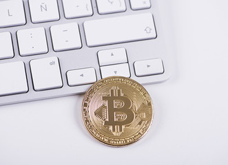 Bitcoin coin on computer keyboard. Cryptocurrency