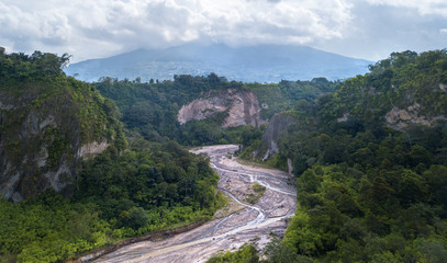 Fototapeta na wymiar View on Ngarai Sianok Canyon, with on the background the volcano Merapi,West Sumatra,Indonesia
