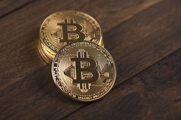 Bitcoin coins on brown wood. Cryptocurrency