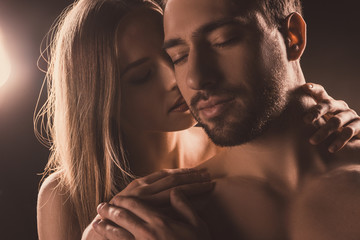 naked sensual lovers hugging with closed eyes