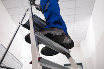 Man Standing On Ladder