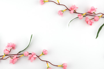Obraz na płótnie Canvas Fake pink flower branches on white background with copy space
