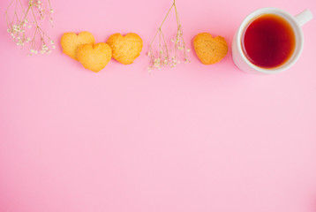 Breakfast for Valentine's Day with tea, cookie heart on a pink background
