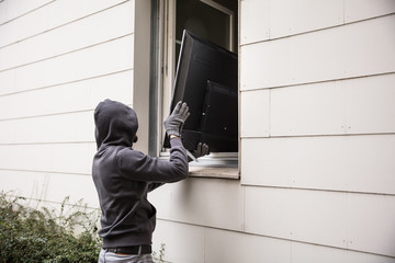 Robbers Stealing Television Through House Window