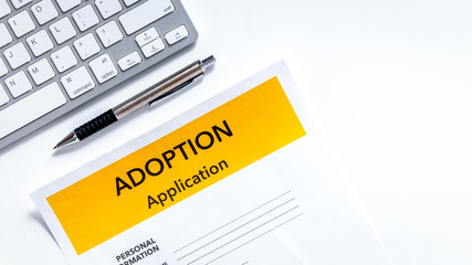 Adoption application near paper silhouette of family and toys on
