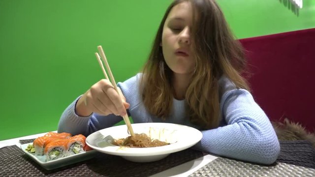 girl eating noodles