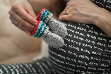 pregnant girl holding booties