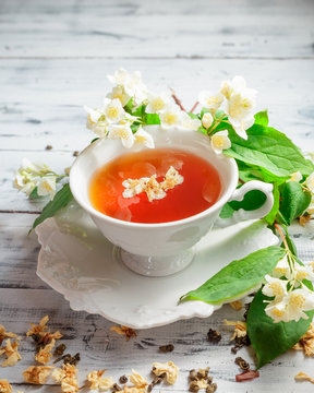 Cup of green tea with jasmine flowers