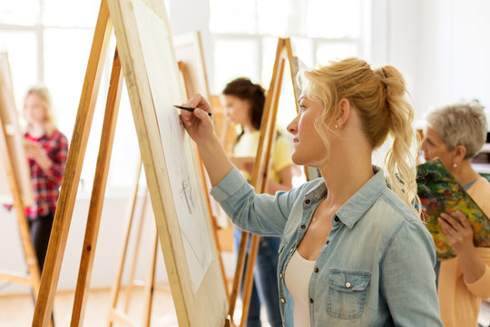 Woman With Easel Drawing At Art School Studio
