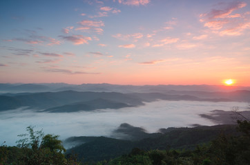 Sunset over mountains and fog