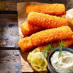 Crispy fried fish fingers with lemon and sauce