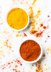 Ground pepper and turmeric on white