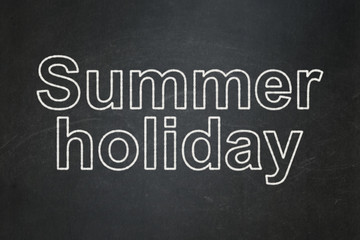 Tourism concept: text Summer Holiday on Black chalkboard background