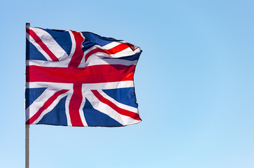 London, Great Britain flag waving against  blue sky, the British flag