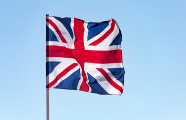 London, Great Britain flag waving against  blue sky, the British flag