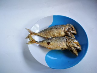 Fried mackerel on the plate. The mackerel fish were cooked by frying. And put them together on a plate