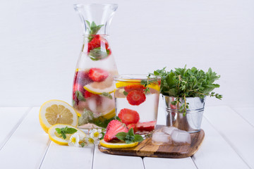 Cold fresh  homemade  lemonade with strawberry and herbs. Detox soda water recipe