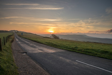 beautiful sunrise over Dorset hills and road