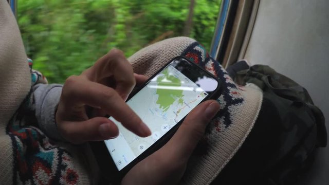 Tourist Traveler Woman With Backpack Using Map In Navigation App On Mobile Phone Traveling By Train. Closeup. 4K.