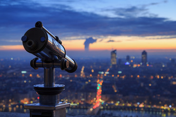 Telescope and view at the city of Lyon, France, at dawn.