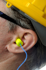 man with protective ear plugs