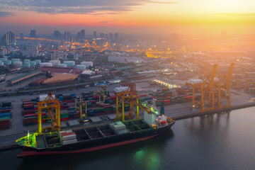 Fototapeta premium Containers yard in port congestion with ship vessels are loading and discharging operations of the transport in international port.