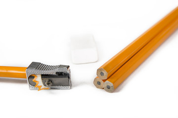 Pencil with pencil shavings and  sharpener with eraser