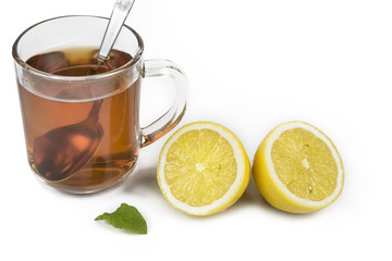 Lemon and cup of tea with mint leaf