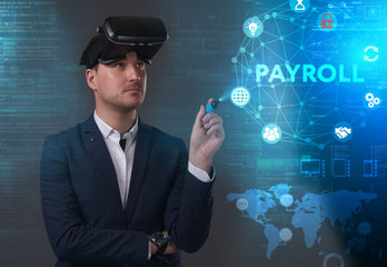 Business, Technology, Internet and network concept. Young businessman working on a virtual screen of the future and sees the inscription: Payroll