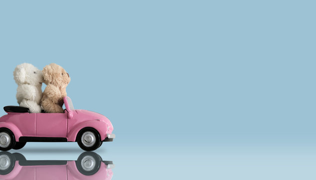 Love Concept Of Couple Teddy Bear Doll On Pink Toy Car On Minimal Style