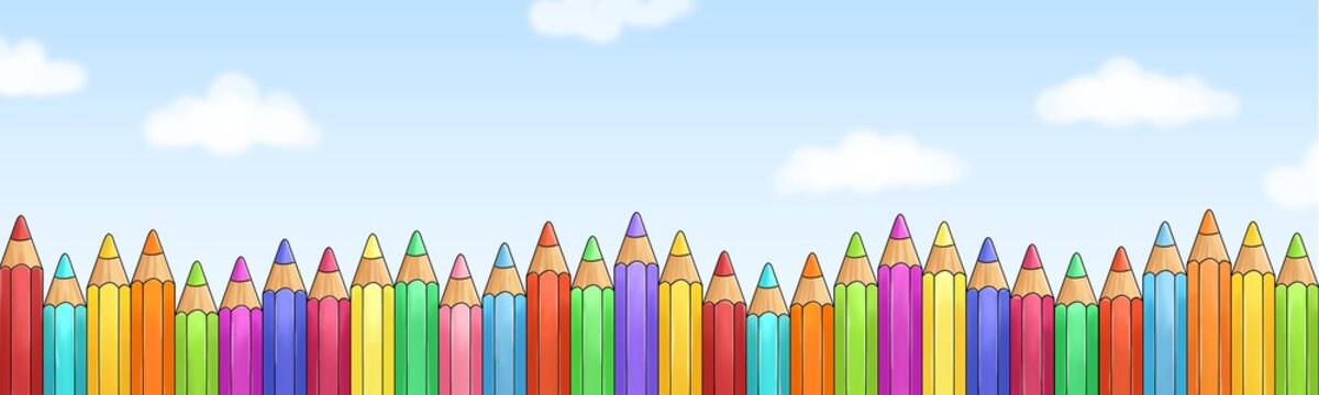 Viele bunte Buntstifte vor blauem Himmel