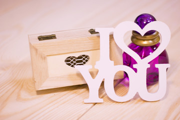 Concept of St.Valentine's Day, Love, Anniversary, Wedding with I love you inscription and gifts in a close up, light blurred background