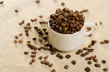 cup with coffee bean on traditional sack textile.