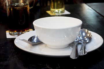 Plate and cup white color on black floor for party.