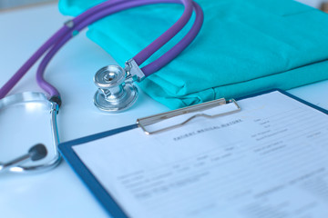 Stethoscope on a table with medical uniform