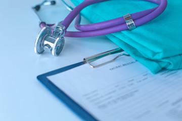 Stethoscope on a table with medical uniform
