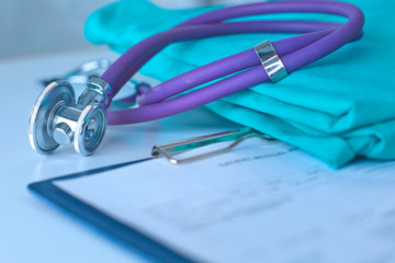 Stethoscope on a table with medical uniform